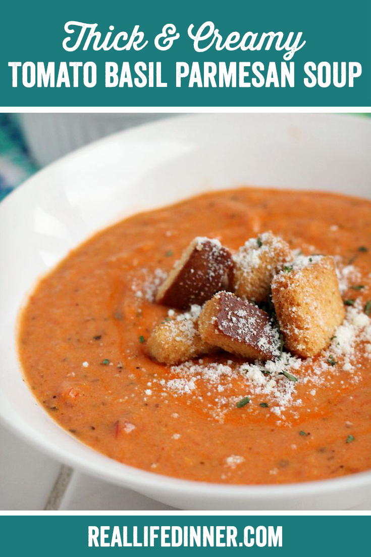 a white bowl of tomato basil soup with croutons in it and a sprinkle of Parmesan cheese