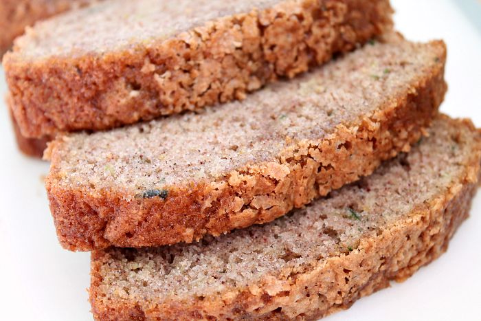 Three slices of zucchini bread laying partially on top of one another.