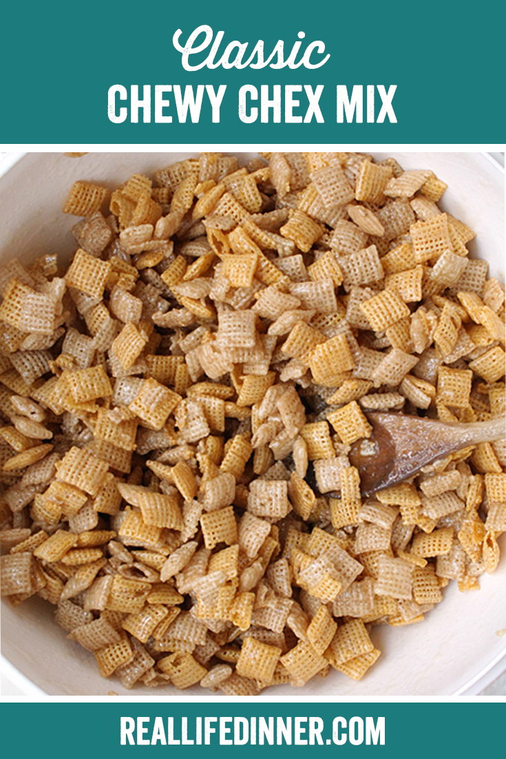 Big bowl of chewy chex mix with a large wooden spoon stirring it. 