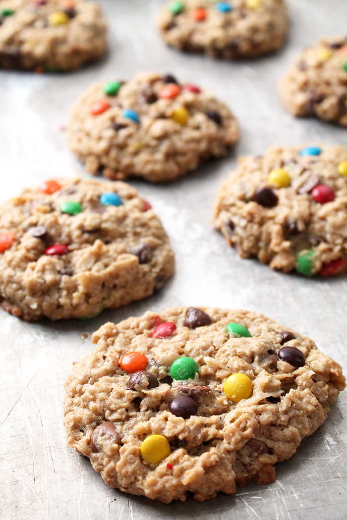 Cookies with M&Ms and chocolate chips on a silver cookie sheet