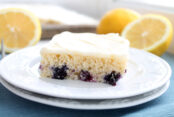 white Sheet cake with blueberries in it. lemons in the background