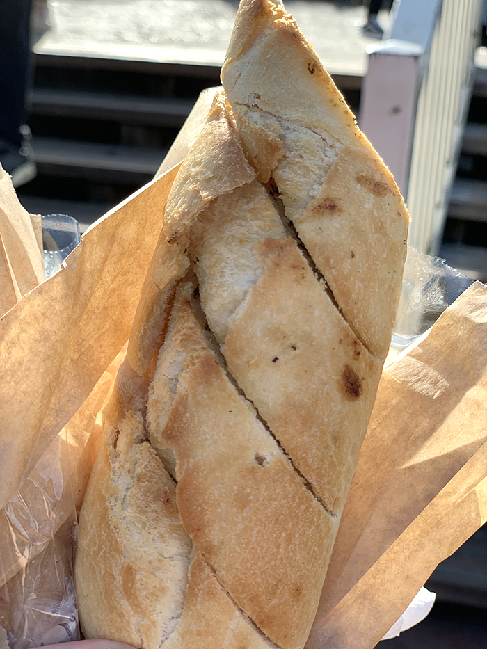 Garlic Bread the size of a skinny baggett. Has slits cut into so it is easy to break apart. It is from Disneyland Paris