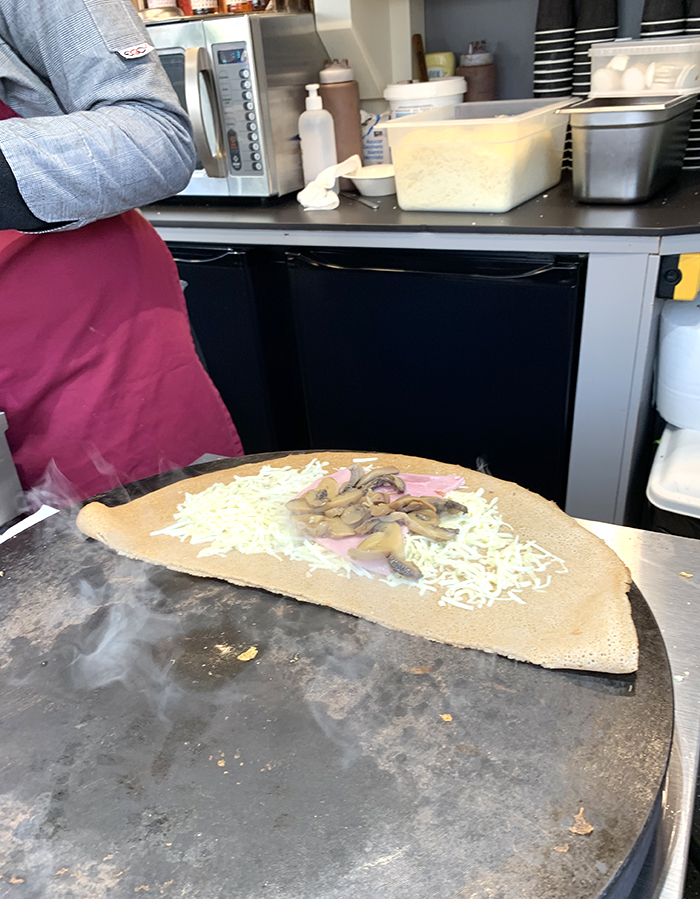crepe cooking on a crepe grill at Disneyland Paris
