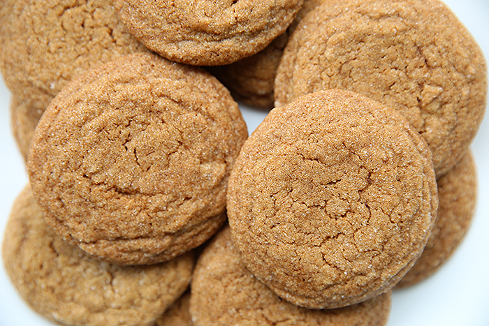 a bunch of gingersnap cookies haphazardly stacked on one another. Like they are on a plate ready to deliver to someone. 