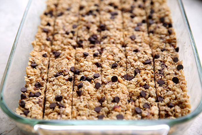 A glass 9x13 pan of cut peanut butter and chocolate chip granola bars.