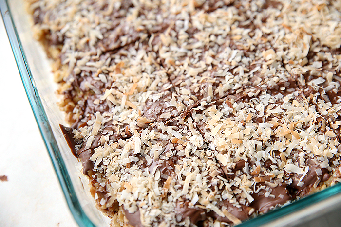 A partial picture of a 9x13 glass pan of Samoa Rice Krispie Treats cut into squares.