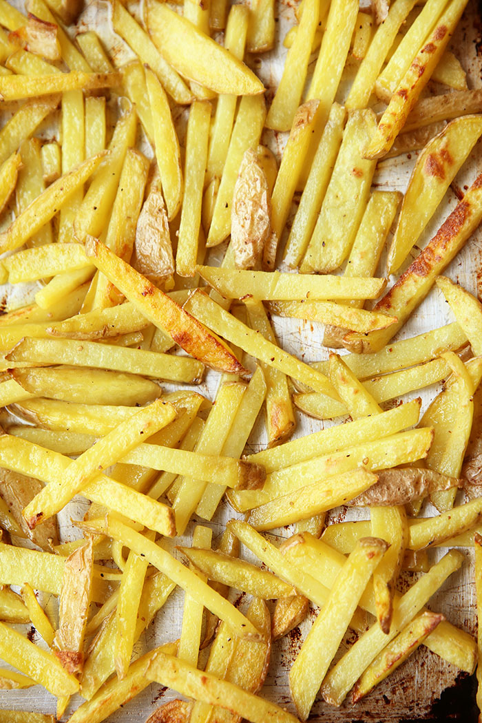 A cookie sheet full of Oven-Baked French Fries.