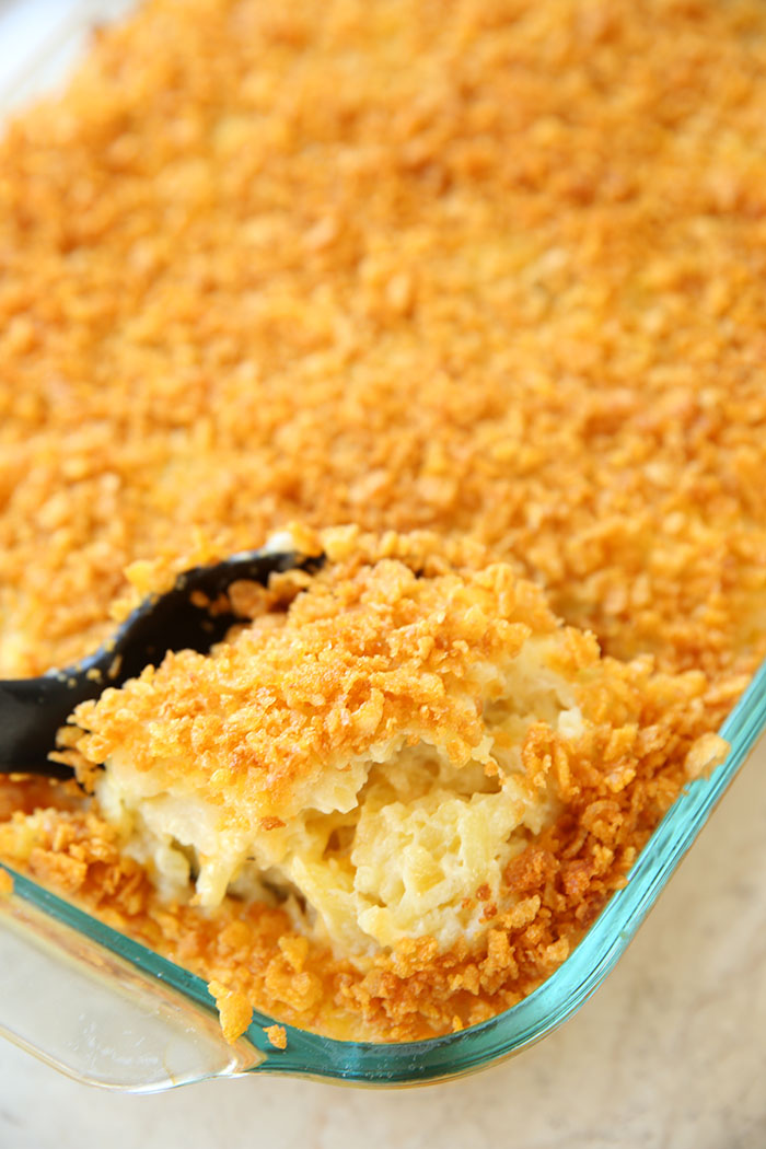 large pan of cheesey potatoes with corn flakes on top. yummy funeral potatoes