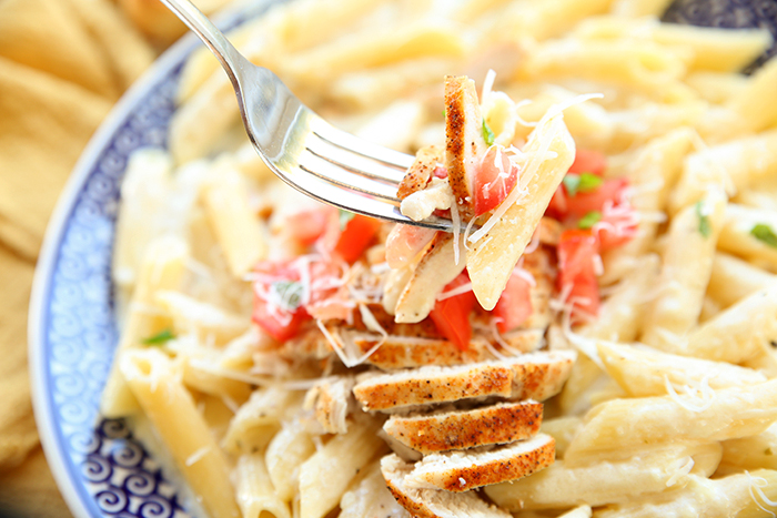 A blue patterned Polish potter plate full of Cajun Chicken Pasta.