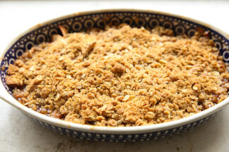 A horizontally placed oval dish of Apple Crisp.