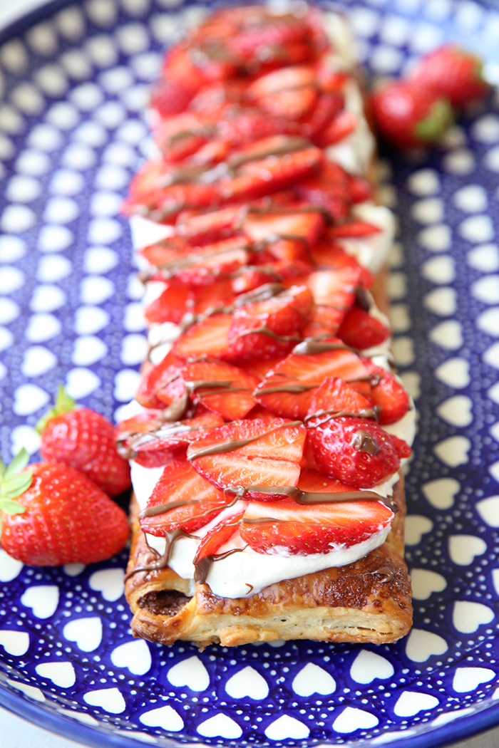 Strawberry Nutella Puff Pastry Dessert on an oval blue Polish pottery plate with white hearts.