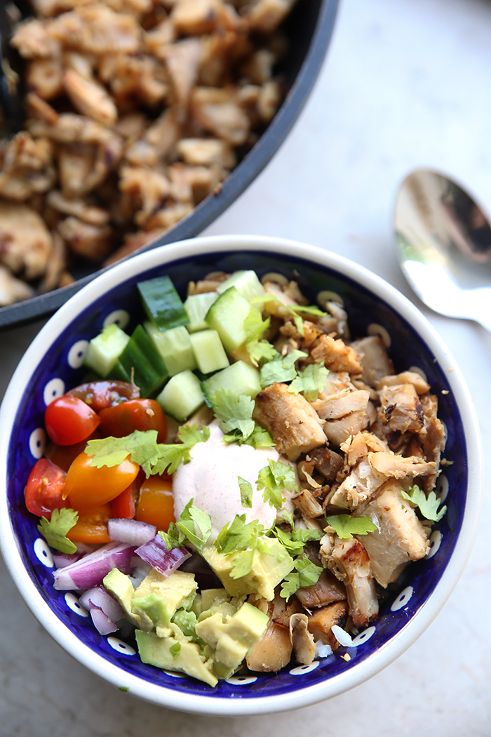 Honey Lime Chicken Bowl with Rotisserie Chicken with a spoon head on the right. Above the bowl is a partial picture of a skillet of chopped rotisserie chicken.