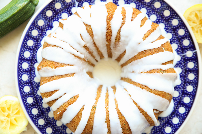 stunning lemon zucchini bundt cake served on a beautiful polish pottery plate