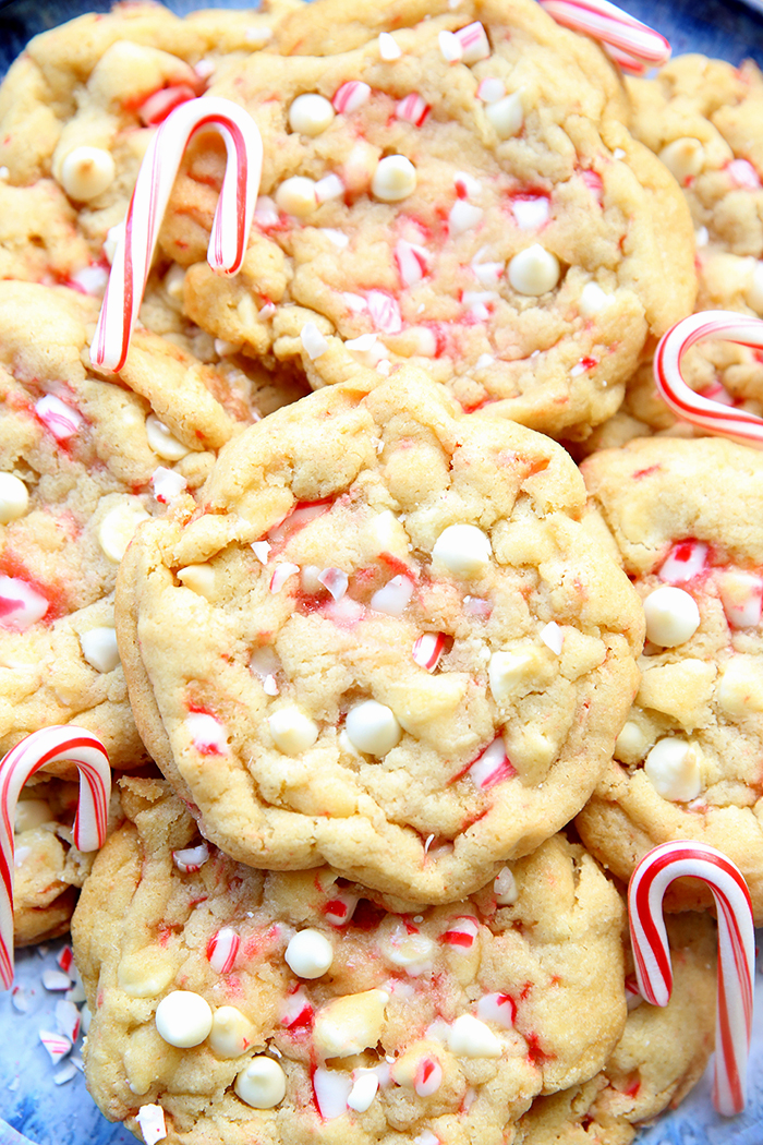 White Chocolate Peppermint Cookies with small candy canes on a large plate.