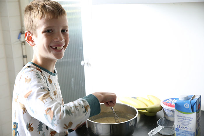 A boy making no-bake banana cream pie.
