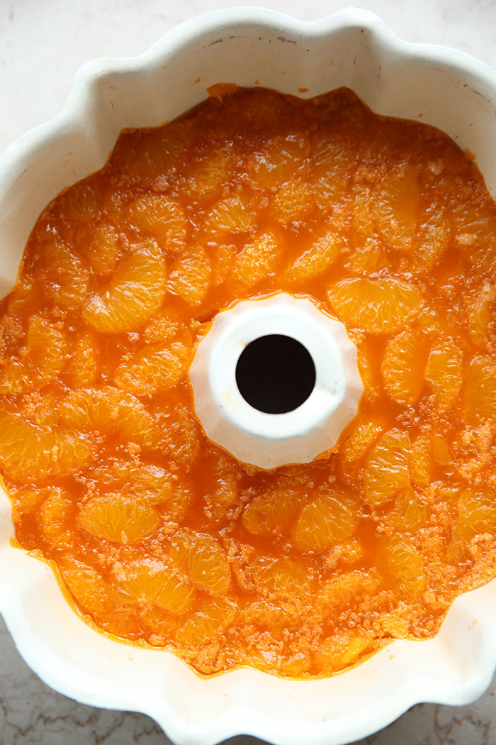 A bundt pan filled with mandarin oranges and orange Jello.