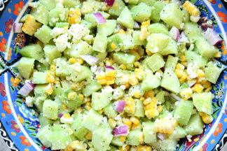 A large bowl of cucumber feta salad with lemon.