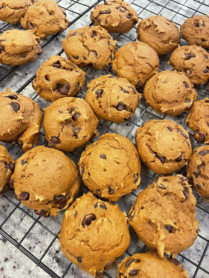 A cooling rack full of pumpkin chocolate chip cookies.