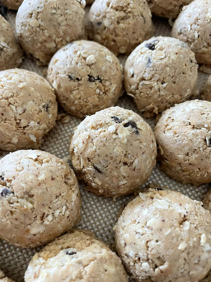 Several protein power balls on a baking mat.
